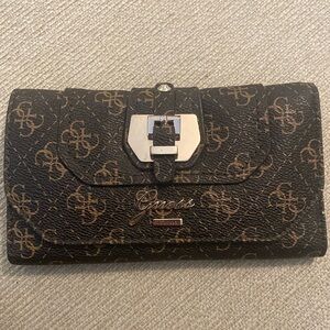 Guess brown wallet with gold accents. Used 2-3 times.